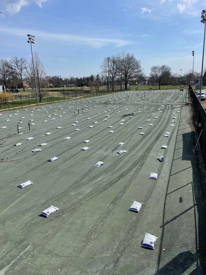 Clay_court_surface_conditioning_and_line_installation